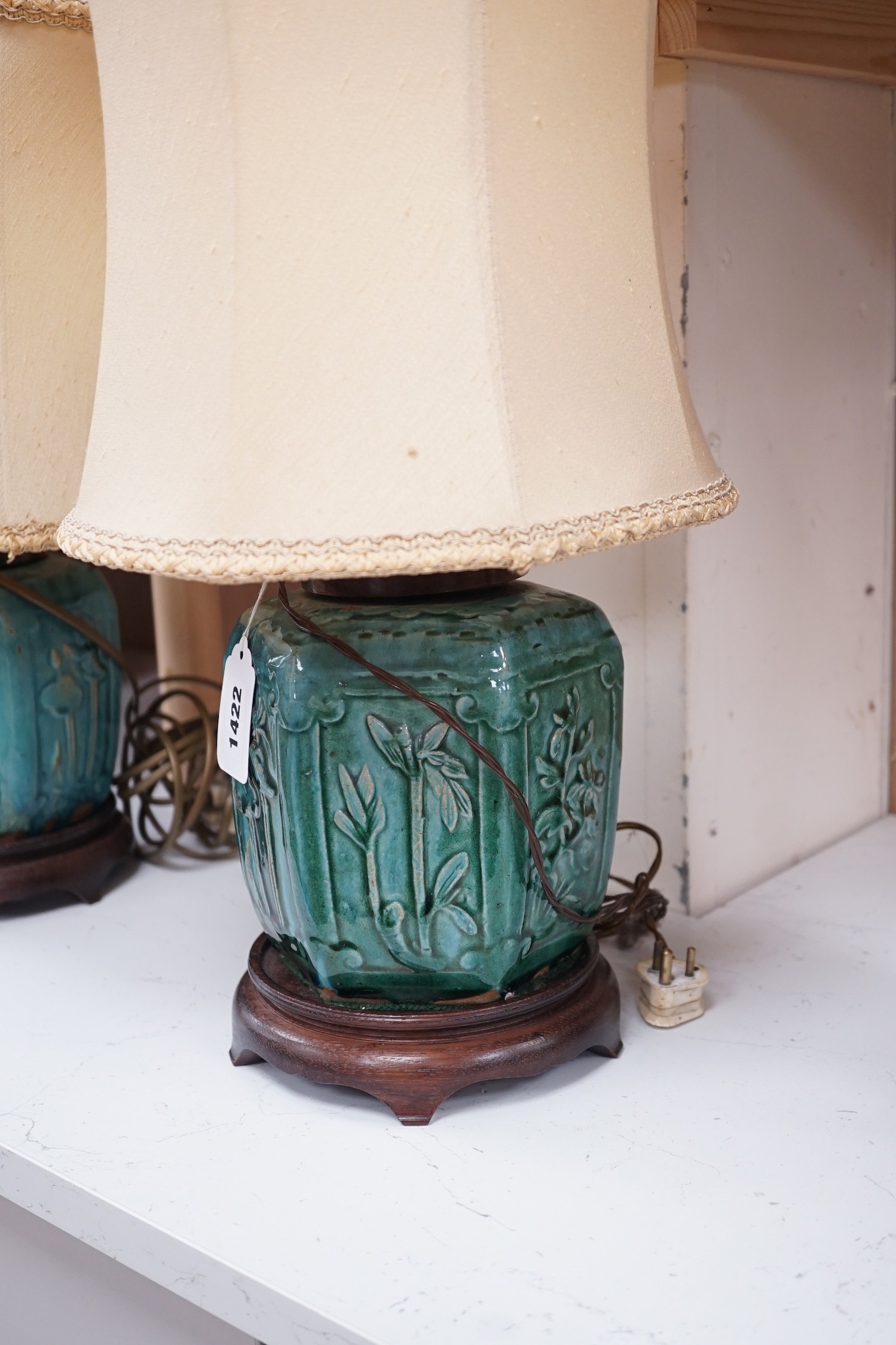 A pair of Chinese blue glazed earthenware hexagonal vase lamps on wooden mounts, with their shades. 45cm tall overall